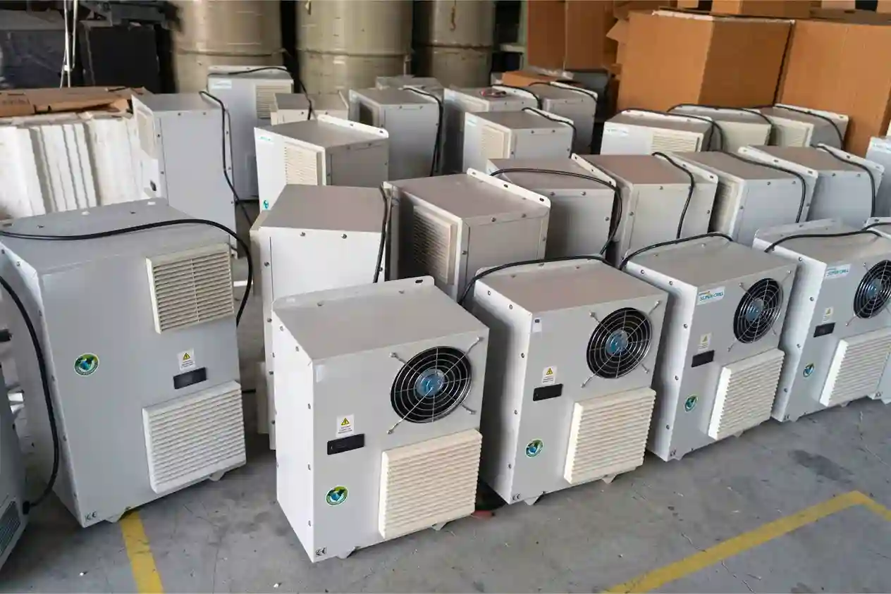Industrial panel air conditioners in a warehouse, designed for electrical panels and enclosure cooling